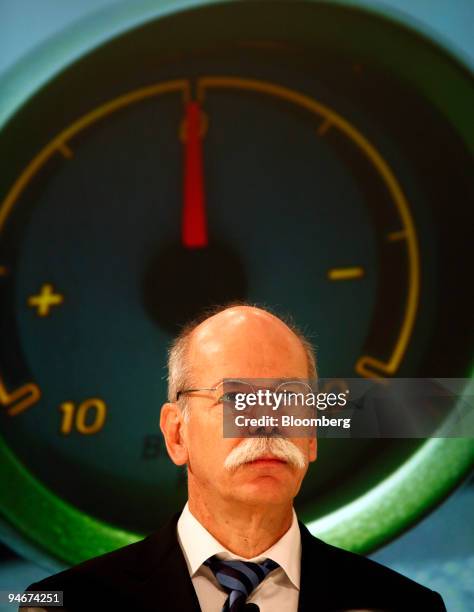 Dieter Zetsche, chief executive officer of Daimler AG, pauses in front of an image of a Smart electric drive automobile's battery indicator at a news...