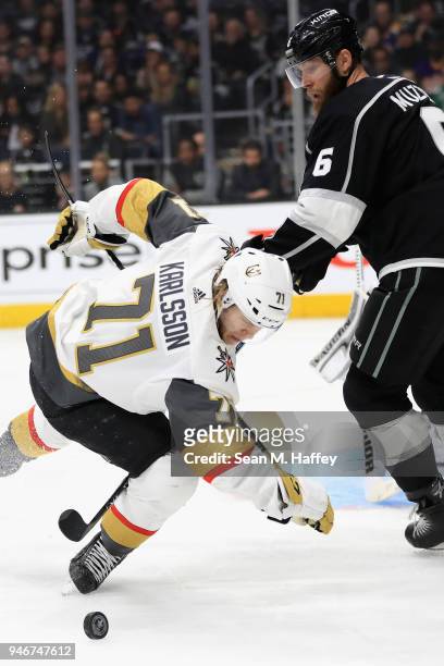 Jake Muzzin of the Los Angeles Kings trips William Karlsson of the Vegas Golden Knights during the third period in Game Three of the Western...