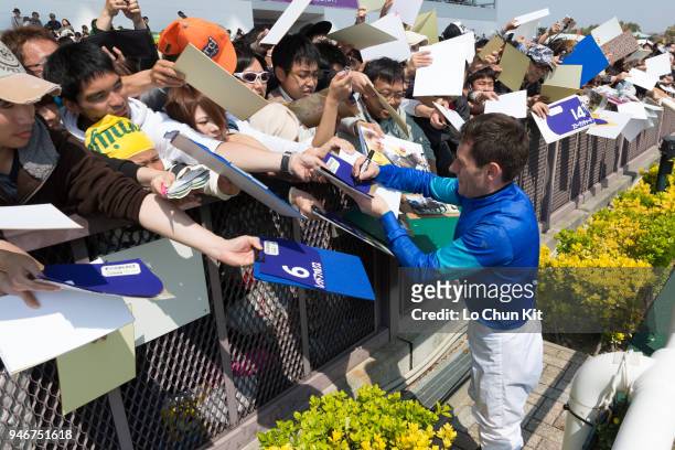 Jockey Mirco Demuro gives his autograph to Japanese racing fans after Moon Chime winning the Race 4 at Chukyo Racecourse on March 25, 2018 in...