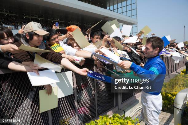 Jockey Mirco Demuro gives his autograph to Japanese racing fans after Moon Chime winning the Race 4 at Chukyo Racecourse on March 25, 2018 in...