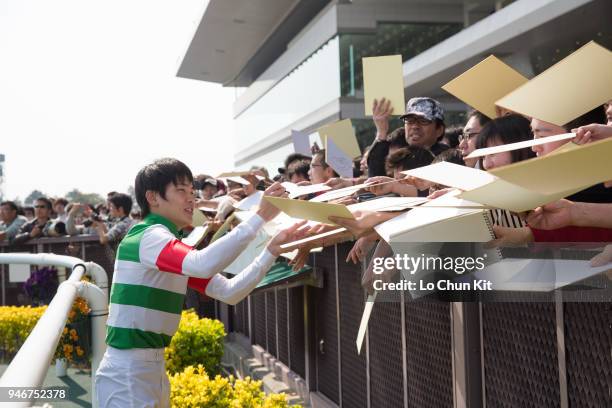 Jockey Kosei Miura gives his autograph to Japanese racing fans after Leirion winning the Race 7 at Chukyo Racecourse on March 25, 2018 in Toyoake,...