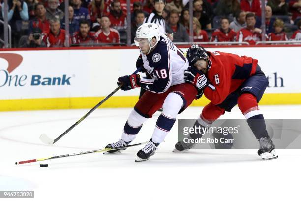 Pierre-Luc Dubois of the Columbus Blue Jackets skates with the puck in front of Michal Kempny of the Washington Capitals during Game Two of the...