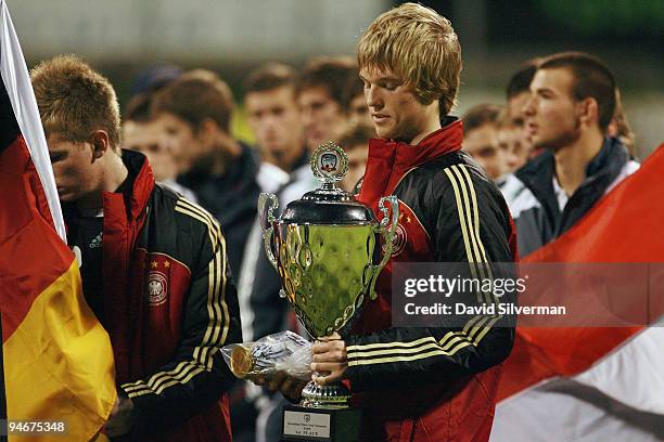 Pelle Jensen, captain of the German Under-18 squad, holds the winners trophy on December 17, 2009 in Kfar Saba, Israel. Germany beat Israel 2-1 in...