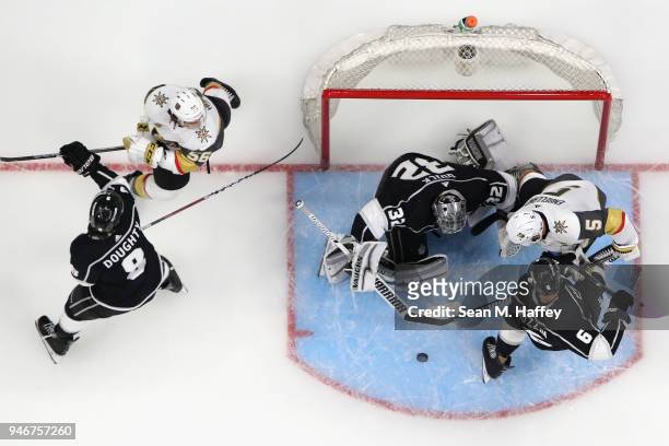 Jonathan Quick, Jake Muzzin and Drew Doughty of the Los Angeles Kings defend against Deryk Engelland and Erik Haula of the Vegas Golden Knights...