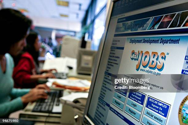 Job seekers work near a job search terminal at a State of California Employment Development Department office and job center in Glendale, California,...