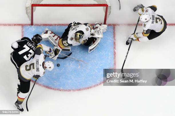 Brayden McNabb, Marc-Andre Fleury and Deryk Engelland of the Vegas Golden Knights defend against Tyler Toffoli of the Los Angeles Kings during the...