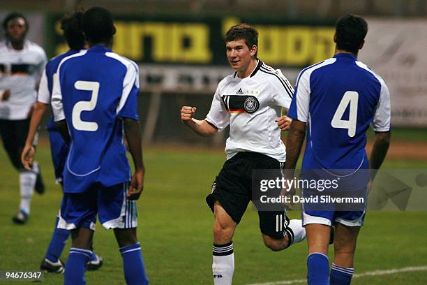 Denis Russ of Germany celebrates after scoring his team's second goal against Israel during an international friendly match on December 17, 2009 in...
