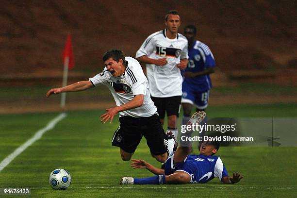 Germany's Denis Russ is fouled by Israel's Micha Dor during an international friendly match on December 17, 2009 in Kfar Saba, Israel. Germany beat...