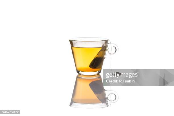 green tea glass cup with bag, isolated on white background - tazza da tè foto e immagini stock