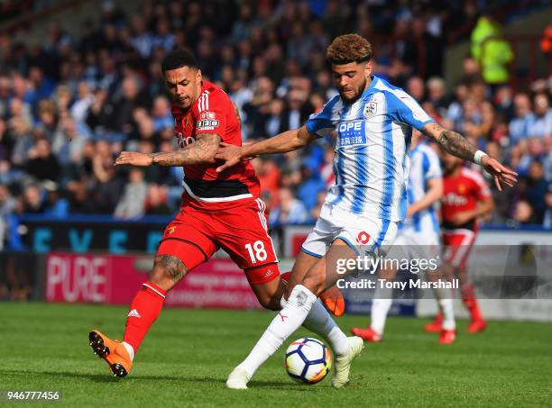 Philip Billing of Huddersfield Town is tackled by Andre Gray of Watford during the Premier League match between Huddersfield Town and Watford at John...