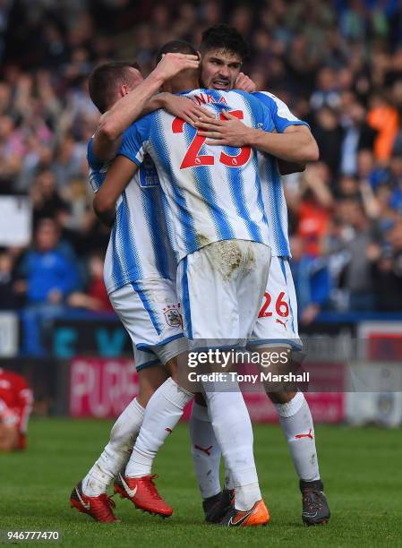 Christopher Schindler, Mathias Zanka and Jonathan Hogg of Huddersfield Town celebrate their win at the final whistle during the Premier League match...