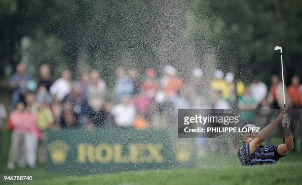 Golfer Tiger Woods plays a shot from a bunker during the HSBC Champions golf tournament in Shanghai on November 7, 2009. US golfer Phil Mickelson...