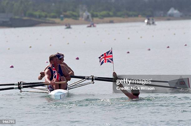 Matthew Pinsent, Tim Foster, Steve Redgrave and James Cracknell of Great Britain are greeted by a fan after winning gold in the Men's Coxless Four...