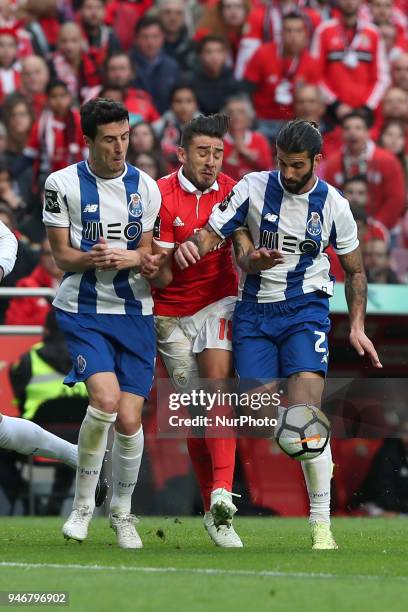 Benfica's Argentine midfielder Eduardo Salvio vies with Porto's Spanish defender Ivan Marcano and Porto's Portuguese midfielder Sergio Oliveira...