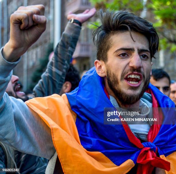 Man raises his fist and shouts during an opposition rally in central Yerevan on April 16, 2018. Around a thousand protesters staged rallies on April...