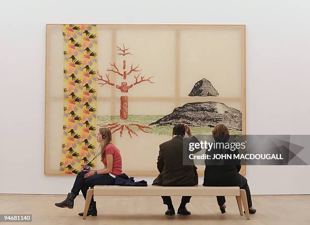 Visitors sit in front of German artist Sigmar Polke's "The Three Lies of Painting" at the Brandhorst museum in Munich December 15, 2009. The...