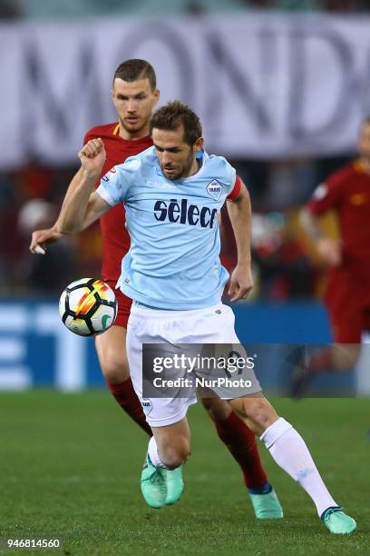 Edin Dzeko of Roma and Senad Lulic of Lazio during the serie A match between SS Lazio and AS Roma at Stadio Olimpico on April 15, 2018 in Rome, Italy.