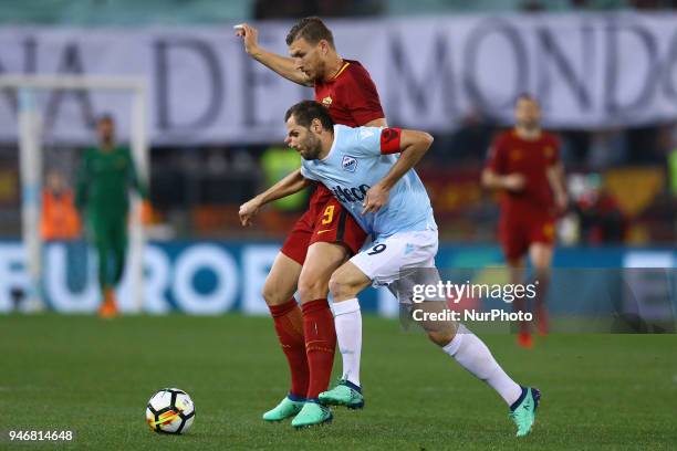 Edin Dzeko of Roma and Senad Lulic of Lazio during the serie A match between SS Lazio and AS Roma at Stadio Olimpico on April 15, 2018 in Rome, Italy.