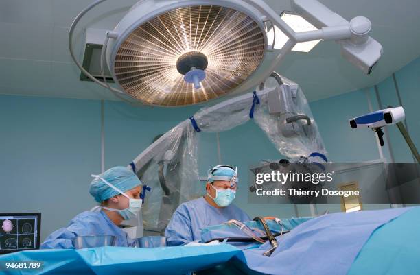 neurosurgery, brain operation - man lying on operating table stock pictures, royalty-free photos & images