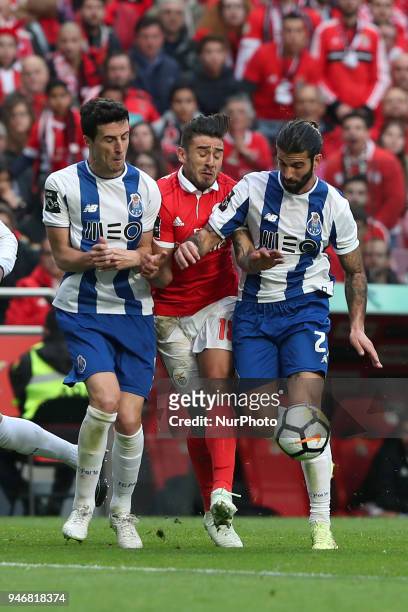 Benfica's Argentine midfielder Eduardo Salvio vies with Porto's Spanish defender Ivan Marcano and Porto's Portuguese midfielder Sergio Oliveira...
