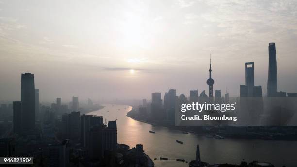 The Shanghai Tower, right, Shanghai World Financial Center, second right, and Oriental Pearl Tower, third right, stand among other buildings in the...