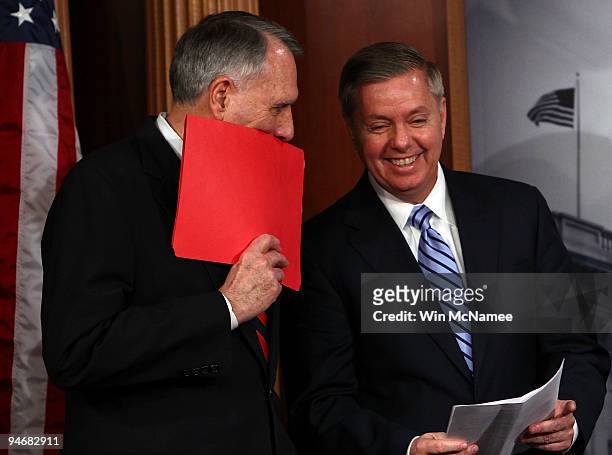 Sen. Jon Kyl confers with Sen. Lindsey Graham during a news conference by Republican Senators to highlight the Obama administration's "attempt to...
