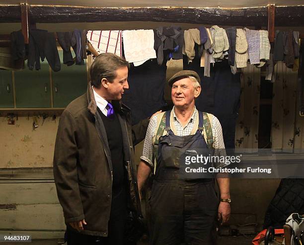 Conservative party leader David Cameron chats to Cockermouth resident and businessman Jim Lawson inside his water damaged home on December 17, 2009...