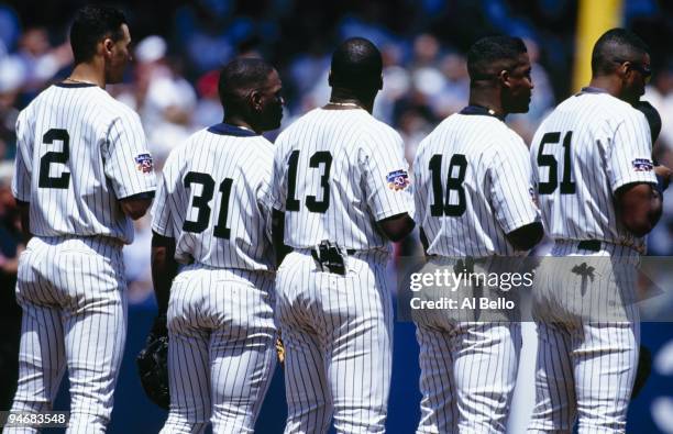 Derek Jeter, Tim Raines, Charlie Hayes, Mariano Duncan and Bernie Williams of the New York Yankees stand for the National Anthem before the game...
