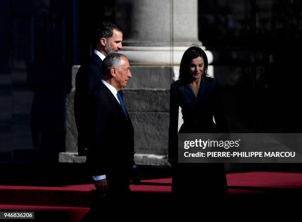 King of Spain, Felipe VI walks with Portuguese President, Marcelo Rebelo de Sousa and Queen Letizia during a welcome ceremony at the Royal palace in...