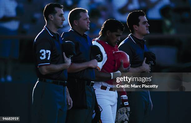Catcher Henry Blanco of the Albuquerque Dukes and umpires stand for the National Anthem before the game against the Omaha Royals at Albuquerque...