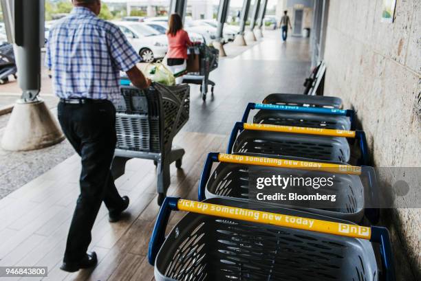 Customers push branded shopping carts as they depart a Pick n Pay Stores Ltd. Supermarket in Johannesburg, South Africa, on Monday, April 9, 2018. As...