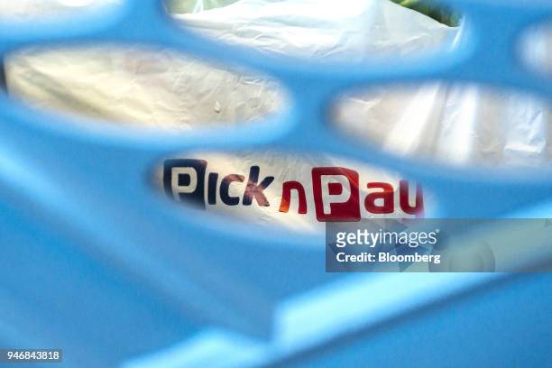 Branded shopping bag sits inside a basket at the check out area inside a Pick n Pay Stores Ltd. Supermarket in Johannesburg, South Africa, on Monday,...