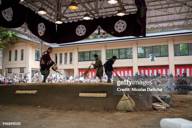 Staff sweep the Dohyo during 'Honozumo' ceremonial on April 16, 2018 in Tokyo, Japan. This annual offering of a Sumo Tournament to the divine at the...