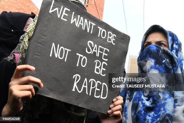 Kashmiri demonstrator holds a placard during a protest calling for justice following the recent rape and murder case of an eight-year-old girl in the...
