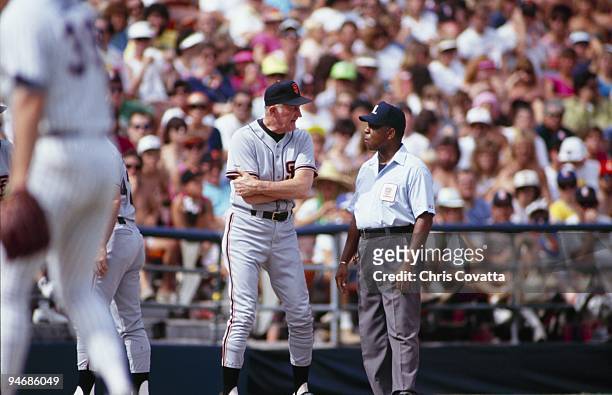 Manager Roger Craig of the San Francisco Giants speaks with umpire Charlie Williams during the game against the San Diego Padres at Qualcomm Stadium...