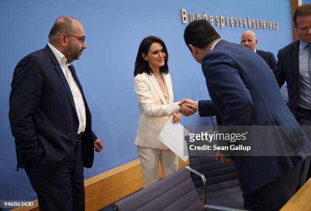 Iranian-born actress and human rights advocate Nazanin Boniadi shakes hands with German politicians and Bundestag members Bijan Djir-Sarai and Omid...