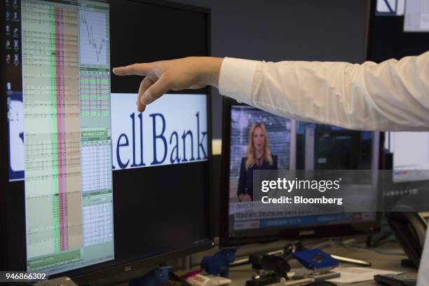 Trader points at financial data on a computer screen inside the Frankfurt Stock Exchange, operated by Deutsche Boerse AG, in Frankfurt, Germany, on...