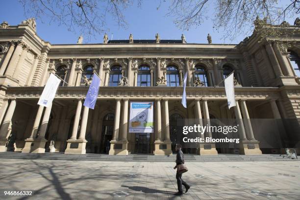 Pedestrian passes outside the Frankfurt Stock Exchange, operated by Deutsche Boerse AG, in Frankfurt, Germany, on Monday, April 16, 2018. Bonds...