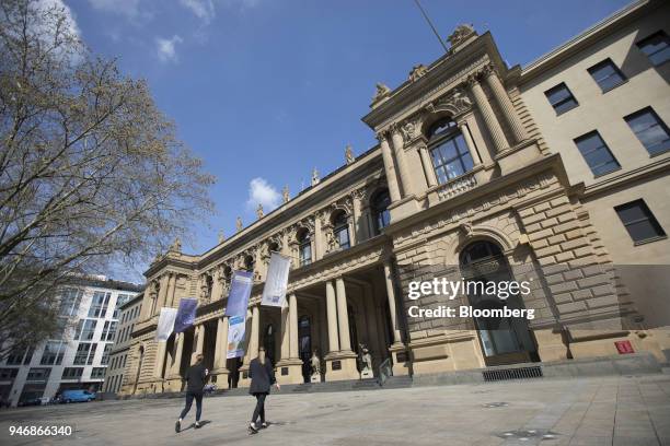 Pedestrians pass outside the Frankfurt Stock Exchange, operated by Deutsche Boerse AG, in Frankfurt, Germany, on Monday, April 16, 2018. Bonds...