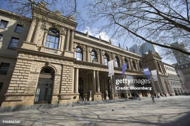 Pedestrians pass outside the Frankfurt Stock Exchange, operated by Deutsche Boerse AG, in Frankfurt, Germany, on Monday, April 16, 2018. Bonds...