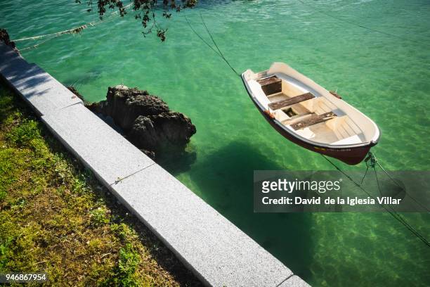 a little boat in calm sea - outboard stock-fotos und bilder