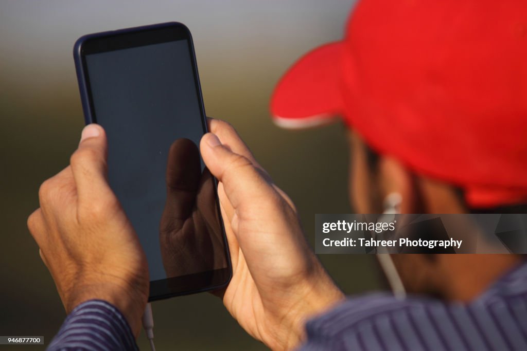 A boy listening songs on smart phone