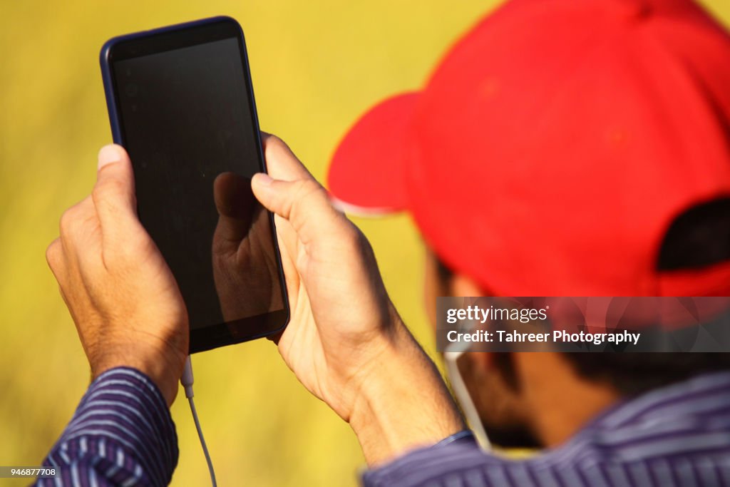A boy listening songs on smart phone
