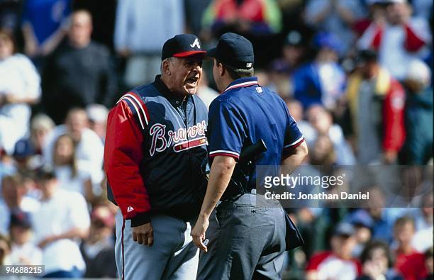 Manager Bobby Cox of the Atlanta Braves argues with umpire Doug Eddings during the game against the Chicago Cubs at Wrigley Field on May 29, 2000 in...
