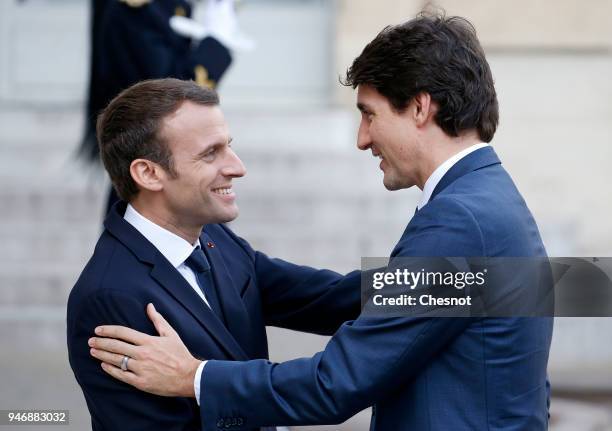 French president Emmanuel Macron welcomes Canadian Prime Minister Justin Trudeau prior their meeting at the Elysee Palace on April 16, 2018 in Paris,...