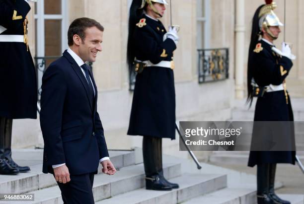 French president Emmanuel Macron waits for Canadian Prime Minister Justin Trudeau prior their meeting at the Elysee Palace on April 16, 2018 in...