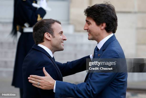 French president Emmanuel Macron welcomes Canadian Prime Minister Justin Trudeau prior their meeting at the Elysee Palace on April 16, 2018 in Paris,...