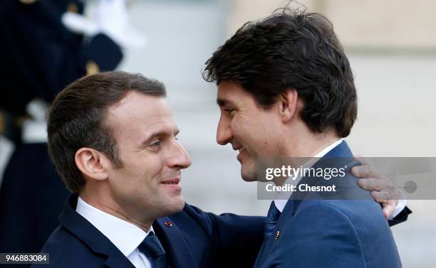 French president Emmanuel Macron welcomes Canadian Prime Minister Justin Trudeau prior their meeting at the Elysee Palace on April 16, 2018 in Paris,...