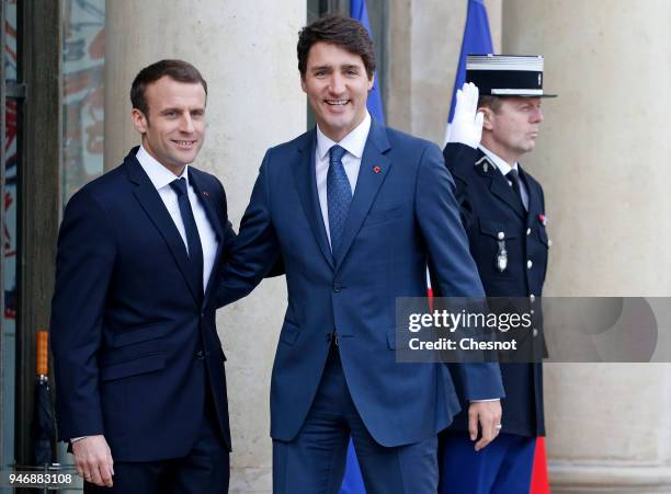 French president Emmanuel Macron welcomes Canadian Prime Minister Justin Trudeau prior their meeting at the Elysee Palace on April 16, 2018 in Paris,...