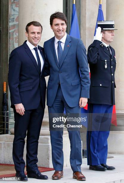 French president Emmanuel Macron welcomes Canadian Prime Minister Justin Trudeau prior their meeting at the Elysee Palace on April 16, 2018 in Paris,...